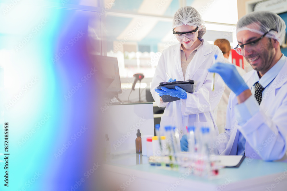 scientists perform experiments and record data. people arranges equipment with test tubes and chemicals for producing medicine and biochemistry. man hold tubes of chemical liquids and plant samples. scientists perform experiments and record data. people arranges equipment with test tubes and chemicals for producing medicine and biochemistry. man hold tubes of chemical liquids and plant samples.