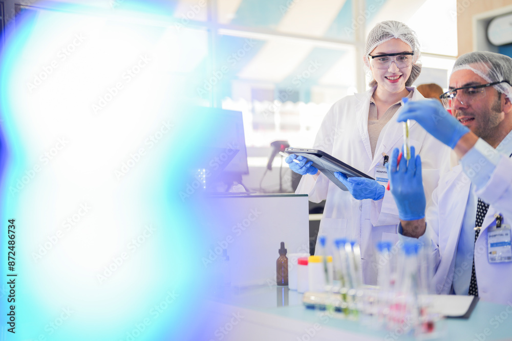 scientists perform experiments and record data. people arranges equipment with test tubes and chemicals for producing medicine and biochemistry. man hold tubes of chemical liquids and plant samples. scientists perform experiments and record data. people arranges equipment with test tubes and chemicals for producing medicine and biochemistry. man hold tubes of chemical liquids and plant samples.