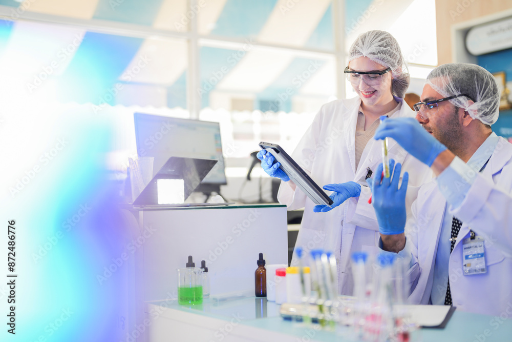 scientists perform experiments and record data. people arranges equipment with test tubes and chemicals for producing medicine and biochemistry. man hold tubes of chemical liquids and plant samples. scientists perform experiments and record data. people arranges equipment with test tubes and chemicals for producing medicine and biochemistry. man hold tubes of chemical liquids and plant samples.