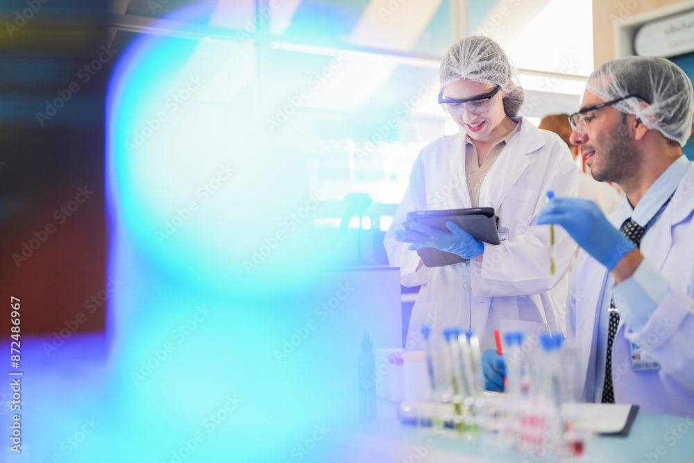 scientists perform experiments and record data. people arranges equipment with test tubes and chemicals for producing medicine and biochemistry. man hold tubes of chemical liquids and plant samples. scientists perform experiments and record data. people arranges equipment with test tubes and chemicals for producing medicine and biochemistry. man hold tubes of chemical liquids and plant samples.