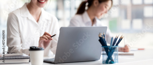 Two young women working together at startup office planning new business