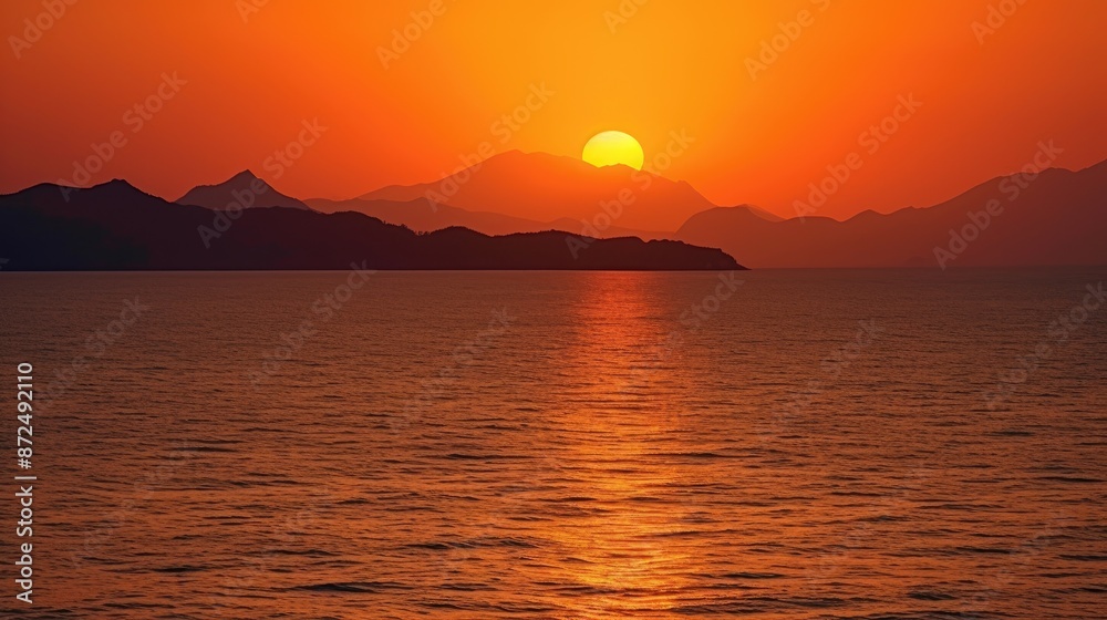 Stunning Sunset Over Mountainous Horizon with Golden Reflections on Calm Sea Stunning Sunset Over Mountainous Horizon with Golden Reflections on Calm Sea