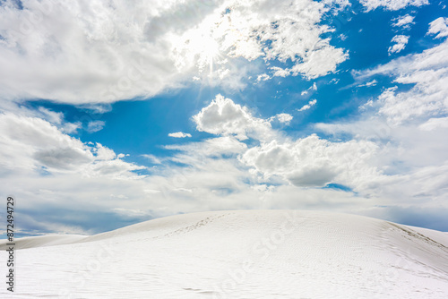 Sunlit Dune and Cloudscape at White Sands National Park