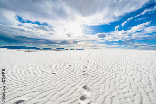 Footprints trail in the White Sands Desert Under a Bright Sky