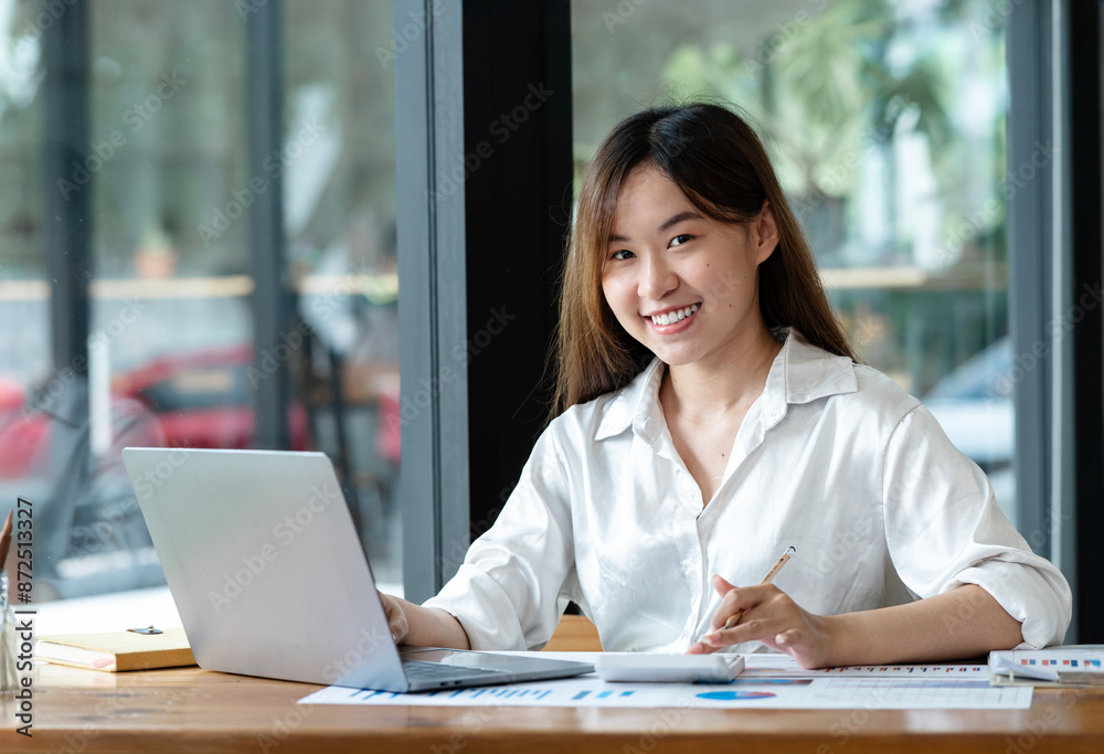 Young Hispanic Asian student using laptop in university campus or at virtual office. College female student learning remotely. Young Hispanic Asian student using laptop in university campus or at virtual office. College female student learning remotely.