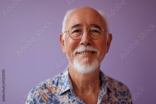 Portrait of a senior man with eyeglasses against purple background