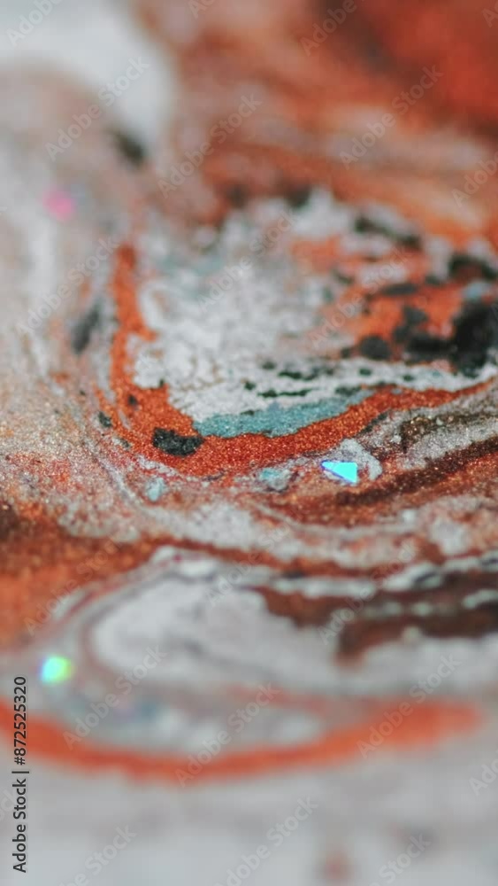 Vertical video. Marble paint texture. Ink spill. Blur orange white black color glitter particles liquid blend flow motion abstract art background. Vertical video. Marble paint texture. Ink spill. Blur orange white black color glitter particles liquid blend flow motion abstract art background.