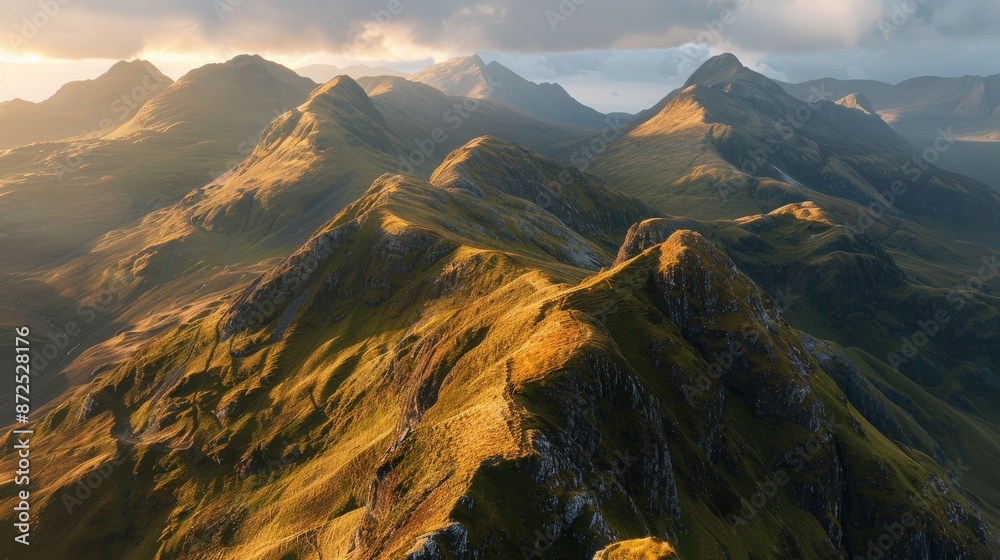 Fototapeta premium Soft sunrise light on a mountain range, casting gentle shadows across the valleys