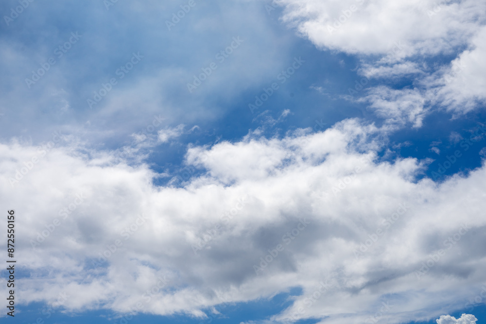 Naklejka premium white clouds on a blue sky background