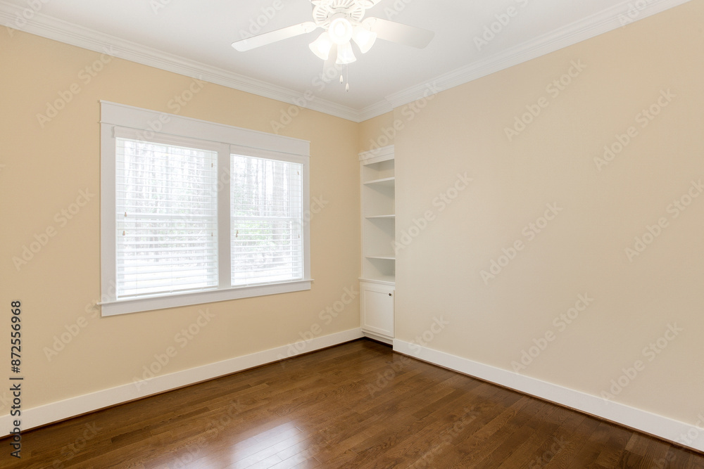 Bright Empty Office With Large Window, Hardwood Floor, And Ceiling Fan Bright Empty Office With Large Window, Hardwood Floor, And Ceiling Fan
