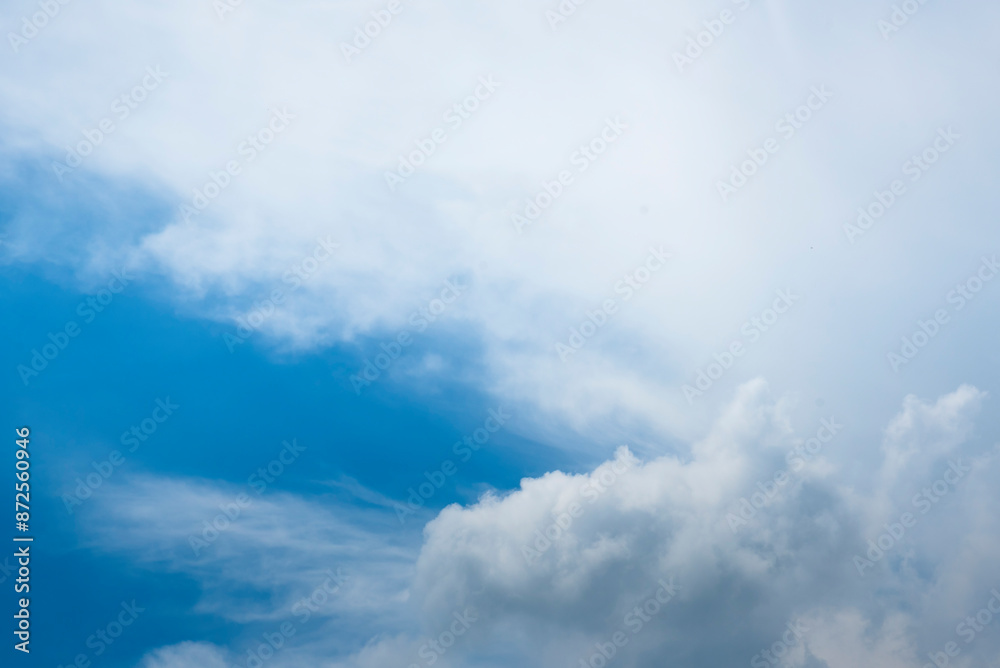 Obraz premium Tropical summer blue sky fluffy white cloud summertime on light sunny day cloudscape. Clear bright blue skyline spring sunlight climate background. Heaven blue environment ecology high scenic nature.
