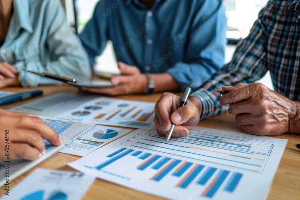 Couple and financial advisor having a focused discussion, with retirement plans and graphs on the table. Couple and financial advisor having a focused discussion, with retirement plans and graphs on the table.