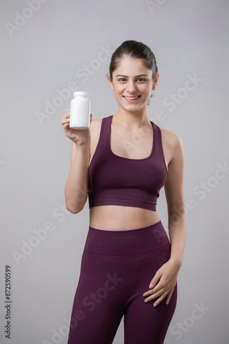 Wallpaper Mural Gym Model Showing Supplement Bottle In Front Of The Camera Torontodigital.ca