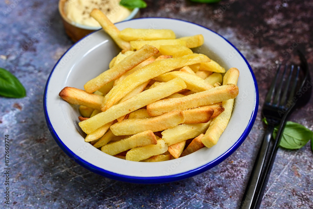 Home made Fresh fried French fries in a bowl on wooden rustic background Home made Fresh fried French fries in a bowl on wooden rustic background