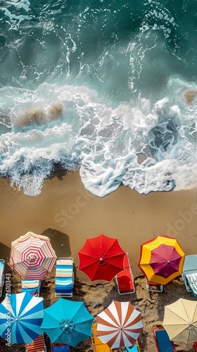 Aerial view of tropical beach scene in summer with beach umbrellas, beach chairs and the sea