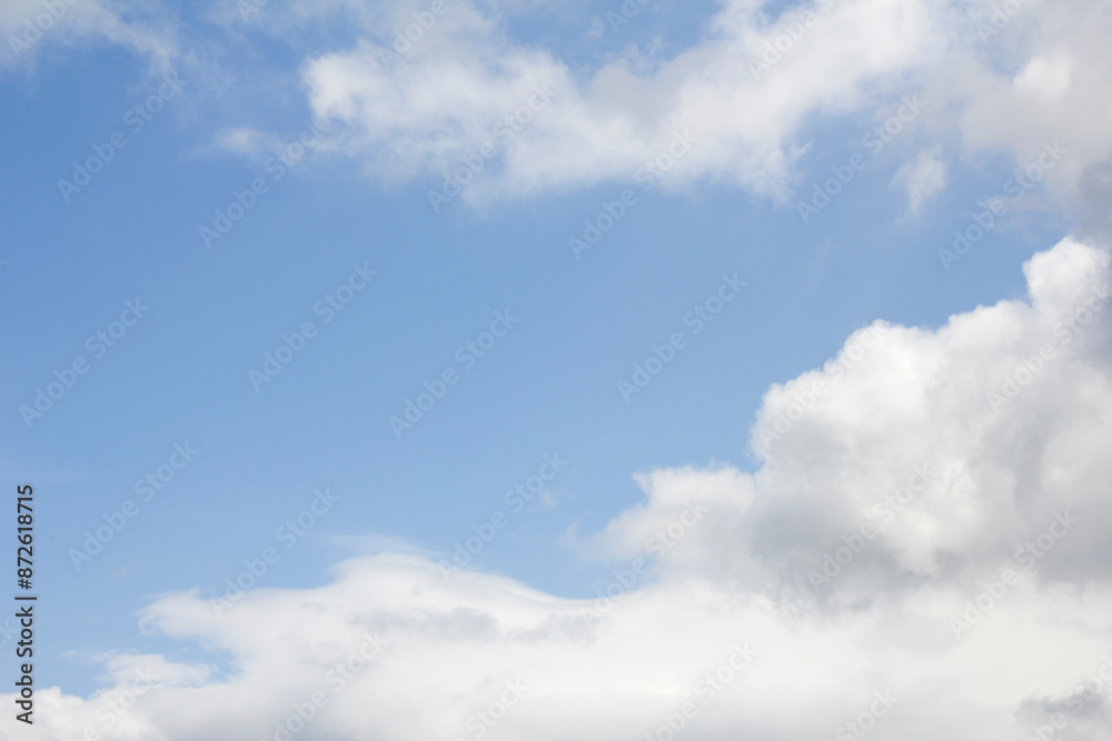 Fototapeta premium Blue sky and white puffy clouds.