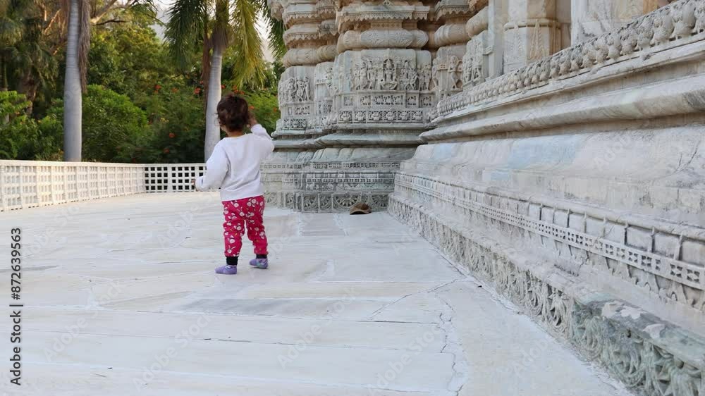 cute toddler walking at temple courtyard at day from unique perspective cute toddler walking at temple courtyard at day from unique perspective