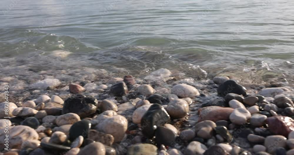 Many stones on sea pebble shore background 4k movie slow motion. Seaside vacation concept Many stones on sea pebble shore background 4k movie slow motion. Seaside vacation concept