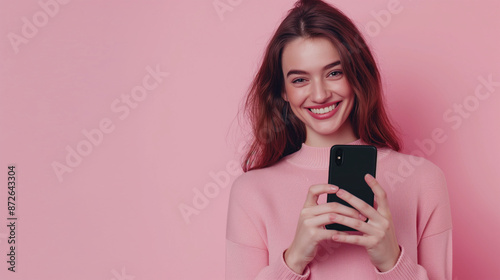 Portrait of a smiling young woman using smart phone