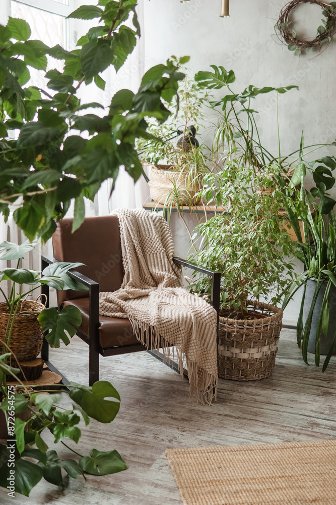 Obraz premium A fragment of the interior with a variety of indoor plants and plaster sculptures. Urban jungle concept. Biophilia design.