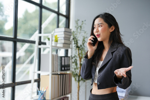 Young Asian woman doing business talking on smartphone. Female accountant. Independent businessman with data documents at desk. Doing business. Contacting customers online. Startup business idea. Free Download Young Asian woman doing business talking on smartphone. Female accountant. Independent businessman with data documents at desk. Doing business. Contacting customers online. Startup business idea. - GFXLoad