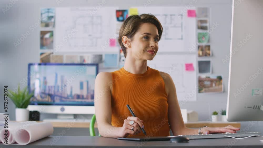 Female architect works on desktop computer in office using graphics tablet- shot in slow motion Female architect works on desktop computer in office using graphics tablet- shot in slow motion
