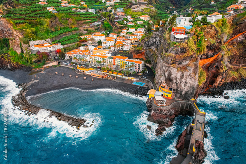 Aerial view of rough ocean with waves, volcanic beach in Ponta do Sol, Madeira, Portugal