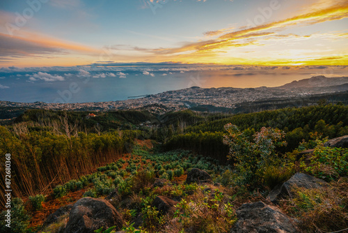 beautiful sunset over the city of Funchal on Madeira from the location Miradouro do Pico Alto. Mountains landscape