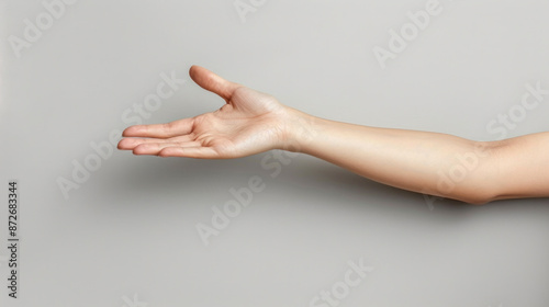 A hand is shown with the thumb up and the fingers spread out. The hand is positioned in a way that it is offering something to someone. Concept of warmth and friendliness