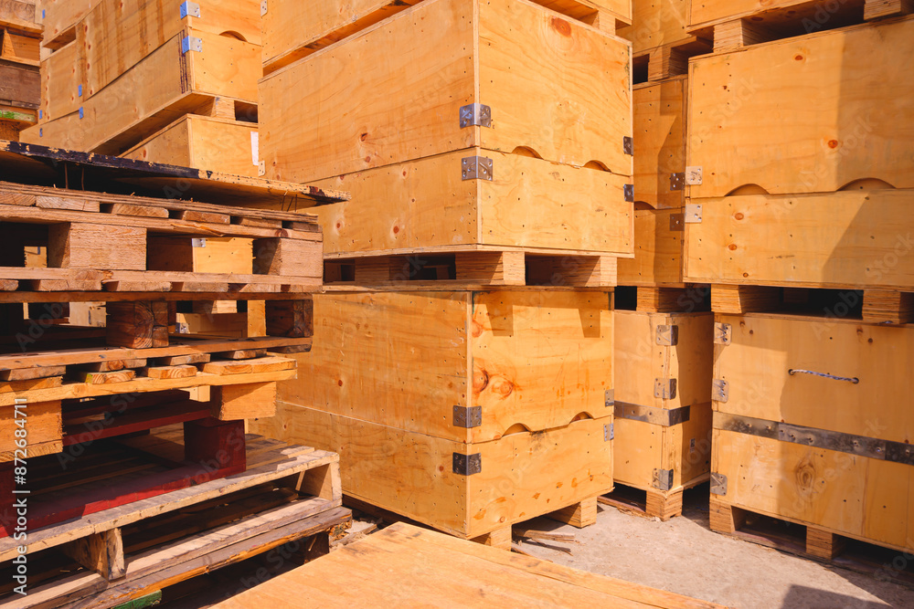 Stack of many the old big wood crates with wooden pallets in yard area of recyclable waste shop for sale and reusable with recycling concept