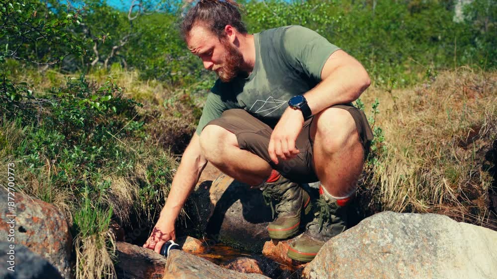 Male Hiker Getting Water From Forest Mountain Lake In Indre Fosen, Norway - Close Up Male Hiker Getting Water From Forest Mountain Lake In Indre Fosen, Norway - Close Up