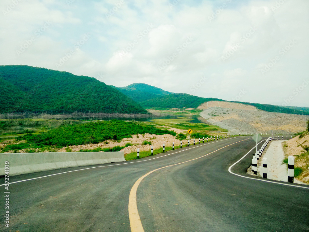 The road is surrounded by mountains. The road is surrounded by mountains.