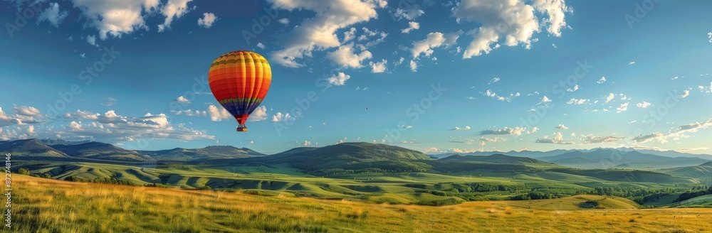Obraz premium Colorful Hot Air Balloon Soaring Over Mountainous Landscape On A Sunny Day