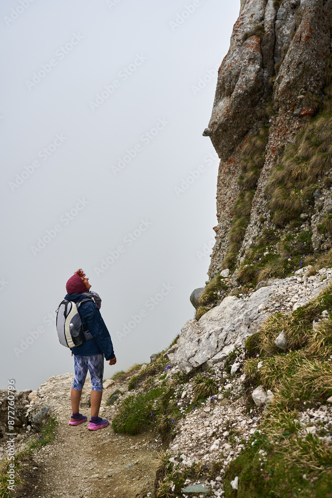 Woman hiker in a rainy day in the mountains Woman hiker in a rainy day in the mountains