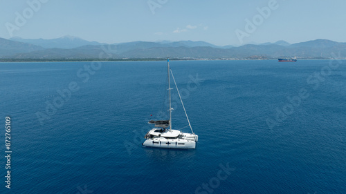 Aerial drone photo of beautiful catamaran sailing yacht anchored in tropical exotic turquoise sea exotic bay