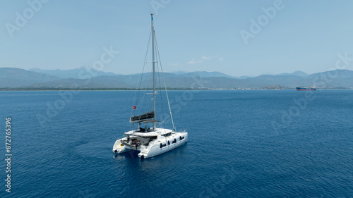 Aerial drone photo of beautiful catamaran sailing yacht anchored in tropical exotic turquoise sea exotic bay