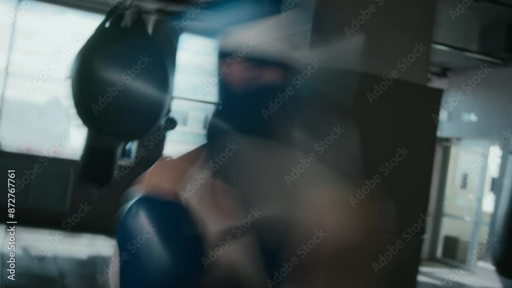 Medium POV shot with slow shutter effect of young Asian female muay thai boxer attacking defending opponent during sparring match in gym with fast-paced jabs aiming at camera