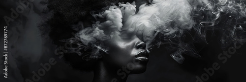 Photograph of an African American woman's head dissolving into smoke against a dark background, creating an eerie atmosphere. © Duka Mer