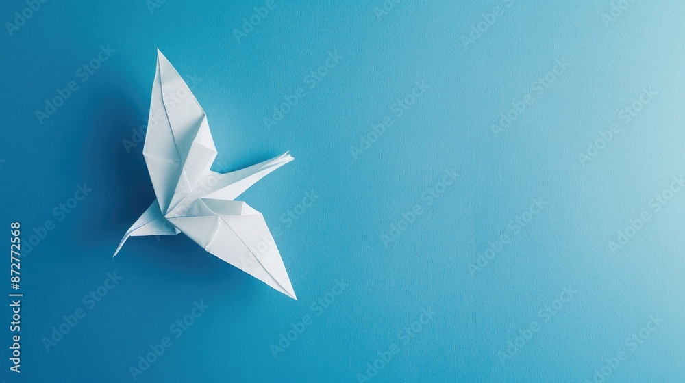 Peace events featuring white paper origami bird on blue background Peace events featuring white paper origami bird on blue background