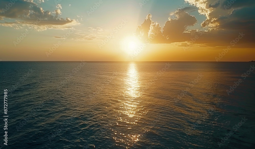 Obraz premium Beautiful sunset over the ocean with a blue sky, scenic view, calm seawater, drone aerial shot