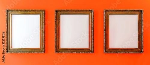Avant-garde gallery mockup with three bronze frames on a bright orange wall background.