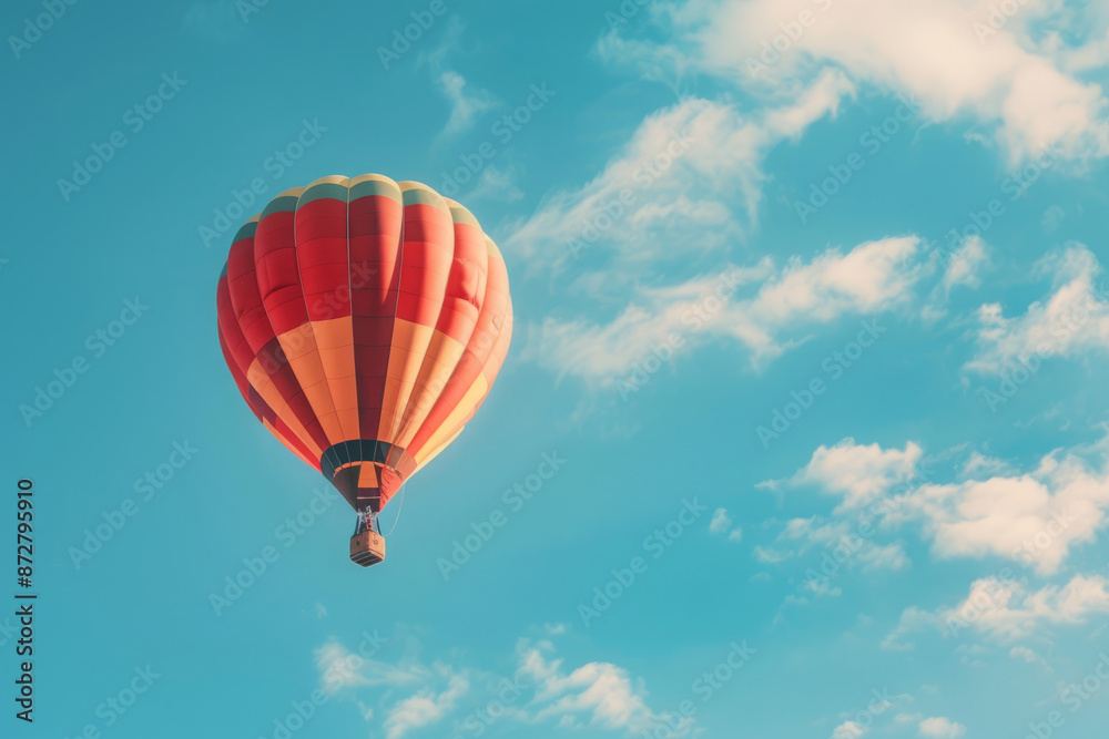 Red hot air balloon flying in clear blue sky. Adventure and freedom concept Red hot air balloon flying in clear blue sky. Adventure and freedom concept