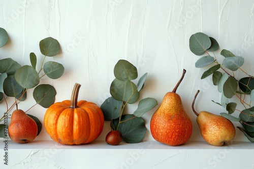 Green Pears and Orange Pumpkins Surrounded by Eucalyptus Leaves