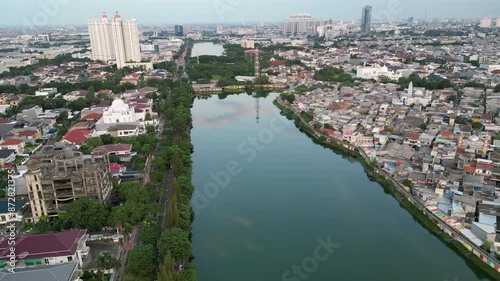 Drone Curves Around Edge Of Sunter Lake North Jakarta Revealing Unfinished Mosque photo