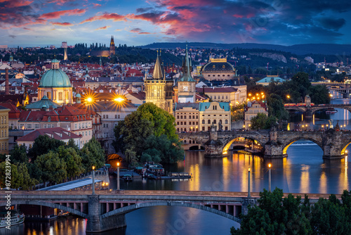 Photography Summer evening view of the illuminated cityscape of Prague, Czech Republic, with
