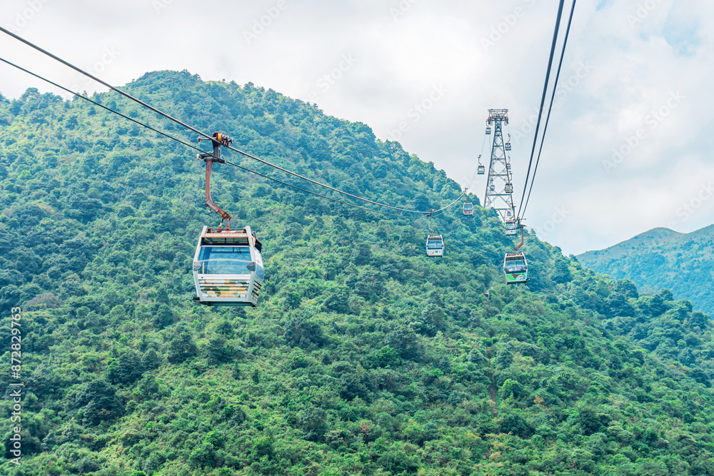 Overhead cable car riding above the mountains. It is one of ...