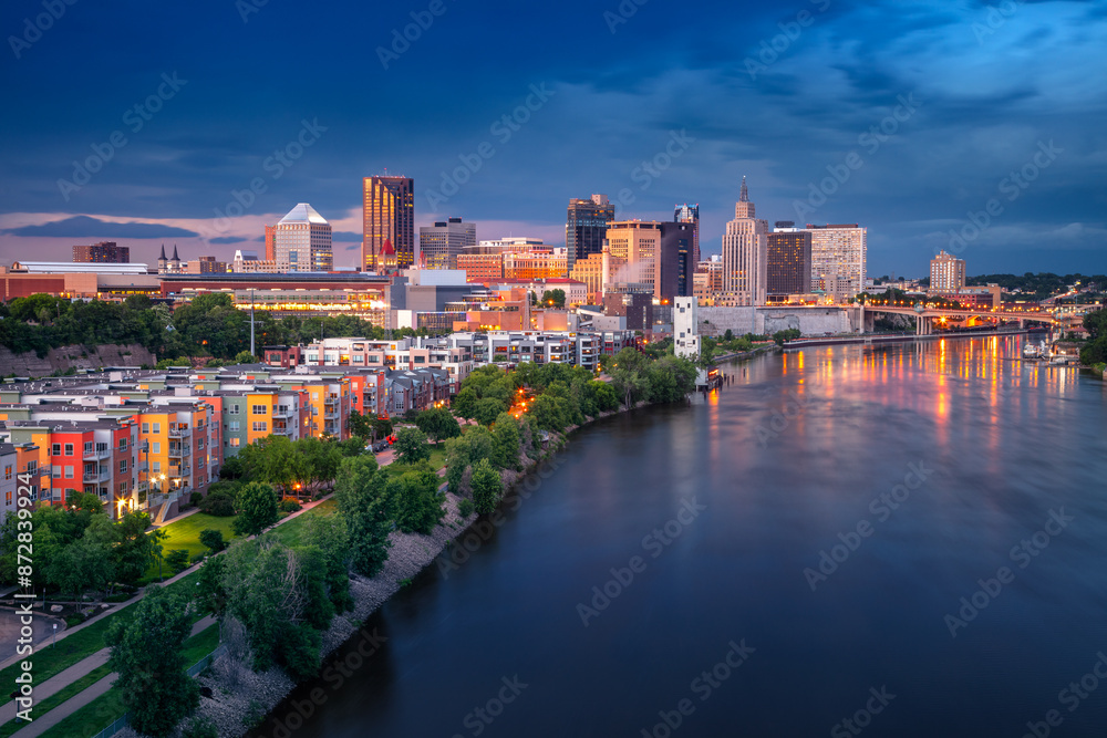 Saint Paul, Minnesota, USA. Aerial cityscape image of downtown St. Paul, Minnesota, USA with reflection of the skyline in Mississippi River at stormy summer sunset.