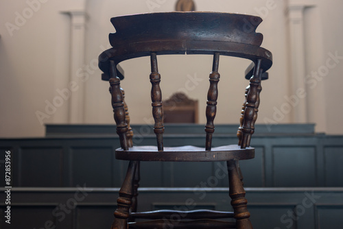 Accused chair in court. Hardwood chair in courtroom.  photo