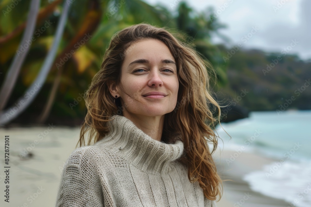 Portrait of a satisfied woman in her 30s dressed in a warm wool sweater isolated in tropical island background Portrait of a satisfied woman in her 30s dressed in a warm wool sweater isolated in tropical island background