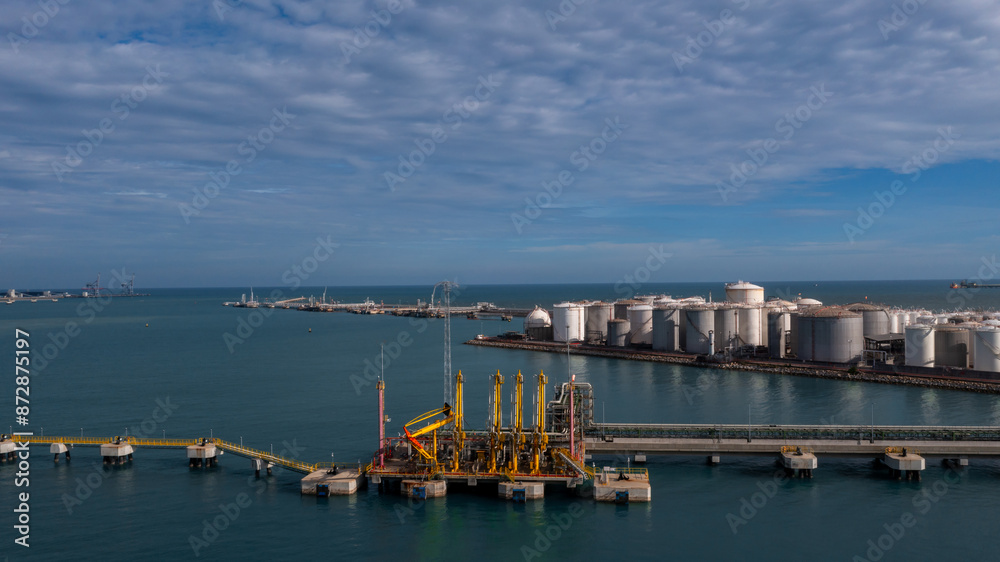 Fototapeta premium Aerial view oil and gas depot industrial facility for storage logistic petrochemical product, Crude oil and gas depot terminal storage tank petroleum petrochemical refinery product, Business energy.